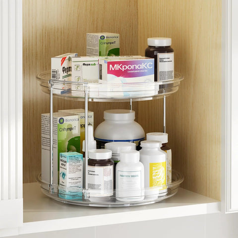 Two-tier clear acrylic Lazy Susan organizer with chrome supports, installed in cabinet, 9.25 in, holding medicine bottles
