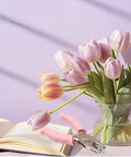 One Quarter Inch Circle Hole Punch, Metal Handheld Paper Punch With Soft Grip Handle, pink, next to flowers and open book