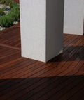 Heavy Duty Liquid Waterproofing Membrane Multi Surface Crack And Leak Repair Coating Interior Exterior Water Based Moisture Blocker Heavy Duty Sealant Easy Brush Application 5 Gallon Sandy Beige applied on wooden deck surface with white columns.