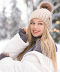 Woman wearing Cozy Winter Beanie Knit Hat For Women Warm Fleece Lined With Faux Fur Pom Poms Thick Ski Skull Cap Beige