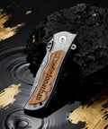 Engraved Custom Pocket Knife For Men, Personalized Name And Message, with premium steel handle on decorative background.