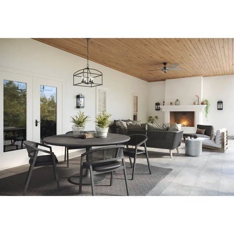 Covered patio with Two Light Outdoor Wall Lantern In Black Finish, Santee Style on walls, seating area, and fireplace view.