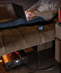 Person using 5000 Watts Modified Sine Wave Inverter For Trucks And RVs, 12V DC To 110V AC Power Converter with USB on sofa