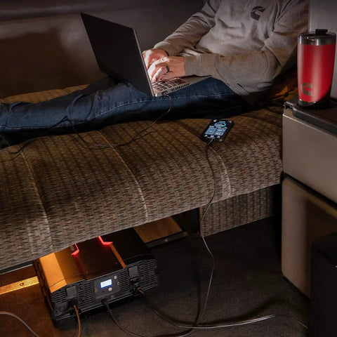 Person using 5000 Watts Modified Sine Wave Inverter For Trucks And RVs, 12V DC To 110V AC Power Converter with USB on sofa