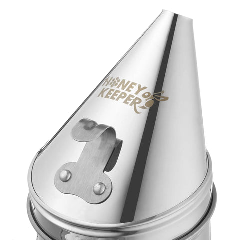 Close-up of stainless steel Pro Grade Beehive Smoker with logo and heat shield for safe hive inspections and calming bees.