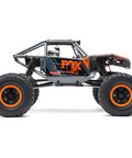 Side view of Capra UTB18 One Eighteenth Scale RC Crawler 4WD RTR with tube chassis and portal axles in multicolor gray.