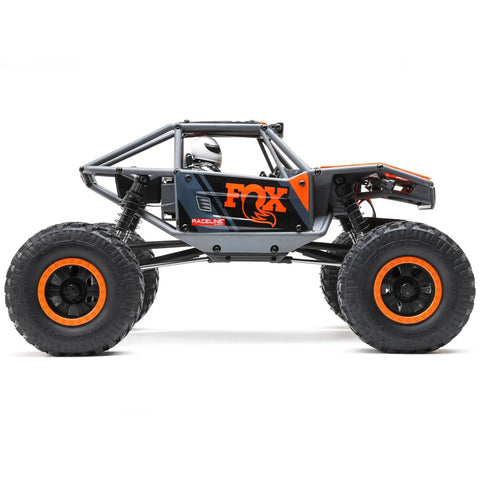 Side view of Capra UTB18 One Eighteenth Scale RC Crawler 4WD RTR with tube chassis and portal axles in multicolor gray.
