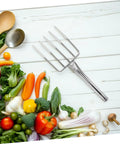 Heavy Duty Garden Fork And Small Shovel For Digging And Transplanting on wooden surface with fresh vegetables