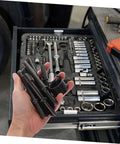 Hand holding tools from Heavy Duty Pneumatic Rivet Tool Kit With Air Chisel for drilling and riveting in mechanic's tool drawer