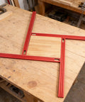 Heavy Duty Adjustable Router Jig For Cutting Boards on a workbench with red aluminum frame and wooden base.