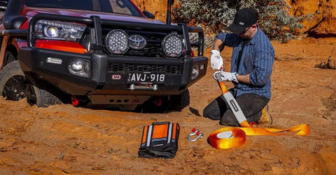 Man using Weekender Offroad Recovery Kit With Snatch Strap 17500 Lb Two 4.75 Ton D Ring Shackles Premium Leather Gloves in desert