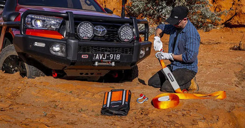 Man using Weekender Offroad Recovery Kit With Snatch Strap 17500 Lb Two 4.75 Ton D Ring Shackles in desert setting