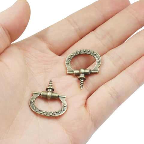 Mini Cabinet Pulls 10 Pack With Self Tapping Screws Antique Bronze Jewelry Box Handles And Drawer Knobs For Small Furniture DIY Projects Slick Zinc Alloy Hardware displayed on hand