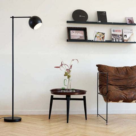 Living room with Molly Floor Lamp In Matte Black With Dope Modern Transitional Design Sleek Ambient Lighting Statement Piece For Living Rooms Contemporary Floor Lamp With Easy Assembly And Versatile Style next to a brown chair and round table.