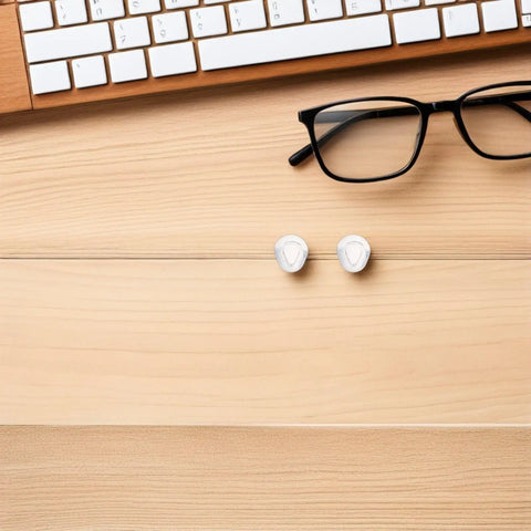 Push In Silicone Nose Pads For Glasses 50 Pack Non Slip Waterdrop Cushions Transparent Anti Sweat Replacement Inserts on wooden desk.