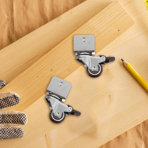 Rugged Swivel Furniture Casters With Gliding Silent Rollers And Tough Round Plates fastened to a wooden board with gloves and pencil.