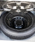 Spare Tire Bolt Retainer Clamp for Vehicle Wheels securing a spare tire inside a car trunk, durable wheel retainer clip visible.