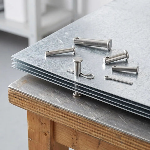 Heavy Duty 122Pcs Stainless Steel Clevis Pins And Cotter Pins Assortment Kit shown on metal sheets on a workbench.