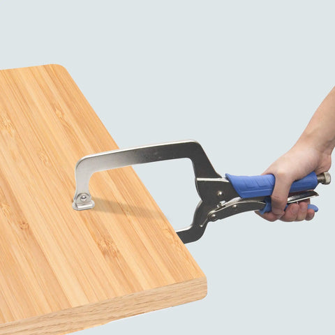 Person using Heavy Duty C Clamp With Swivel Pads Vise Grip Locking Pliers 18 Inch Face Clamp for securing a wooden board.