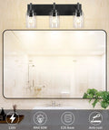 Vintage Vibes Wall Light Fixture With 3 Clear Glass Shades In Matte Black Finish illuminating a bathroom mirror