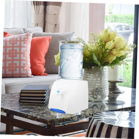 Compact Desktop Cold Water Dispenser With Easy Press Button Operation displayed on a coffee table in a living room setting