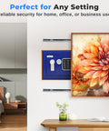 Premium Steel Digital Safe Box With Electronic And Mechanical Access For Cash Jewelry And Small Guns Compact 9.1 Inch By 6.7 Inch By 6.7 Inch Lockbox in a home setting, installed behind framed art.