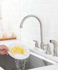Brushed Nickel Kitchen Faucet With Sprayer, 2-Handle High Arc Sink Faucet, 360 Degree Swivel, 3 Or 4 Hole Install, For Kitchen RV Utility Sink, Lead Free Ceramic Cartridge, SUS304 Stainless Steel in use washing a plate