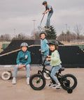 Children at a skatepark, one on a 16 Inch Kids Bike For Ages 4 And Up, BMX Style Youth Bicycle With Training Wheels, Coaster Brake.