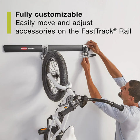 Person adjusting bicycle on Garage Wall Storage Kit With FastTrack Rails Hooks Shelves And Cabinets Built To Last Heavy Duty Steel