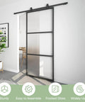 Dope 36-Inch By 84-Inch Frosted Glass Barn Door With Six-Foot Top Mounted Hardware Kit Includes Soft Close Mechanism, Black Carbon Steel Frame, installed view in living space.