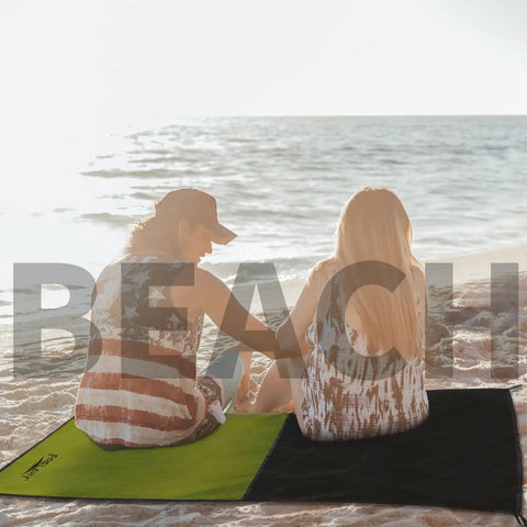 Couple on beach with Pocket Sized Picnic Blanket Waterproof And Sandproof Beach Mat For Festivals Hiking Travel And Outdoor Adventures