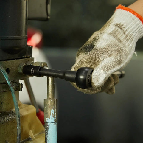 Gloved hand using Impact Socket Set 33 Piece Three Eighths Inch Drive With Seventy Two Tooth Reversible Ratchet Wrench on machinery