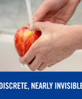 Hands washing an apple with Advanced Healing Waterproof Bandages Assorted Sizes 10 Count - Gel-Cushioned, Diamond Seal, Ultra-Thin on finger.