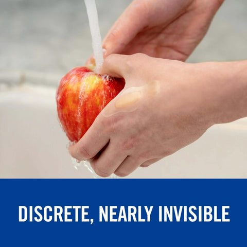 Hands washing an apple with Advanced Healing Waterproof Bandages Assorted Sizes 10 Count - Gel-Cushioned, Diamond Seal, Ultra-Thin on finger.