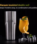 Boss Level Heavy Duty Double Wall Vacuum Insulated Cocktail Shaker Bottle next to an orange cocktail with mint garnish.