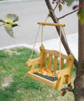 Set Of 2 Wooden Swing Bird Feeders For Outdoor Hangin With Metal Mesh Bottom, bench style hanging on tree with bird approaching