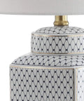 Close-up of 21.5 inch white and navy ceramic ginger jar LED table lamp with fishnet chinoiserie pattern and brass gold base