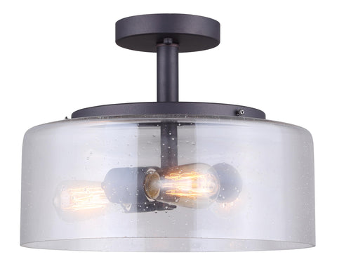 Nash 3 Bulb Semi Flush Light With Seeded Glass In Oil Rubbed Bronze Finish displaying lit bulbs and modern rustic design.