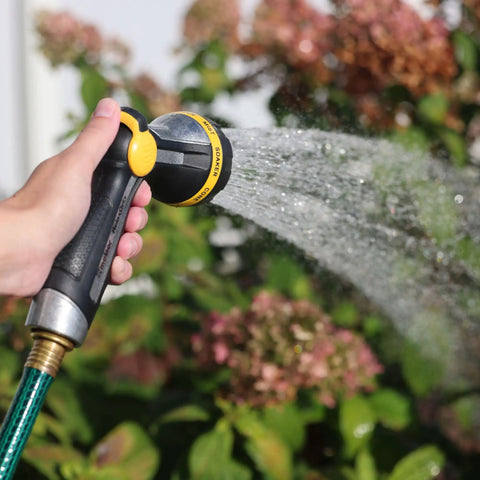 RelaxGrip Metal Garden Nozzle With Multi Pattern Spray Arthritis Foundation Ease Of Use Certified Quick Connect Bundle Durable Metal Threads Pain Free Grip For Hands And Wrists Black And Yellow spraying water on flowers