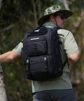 Man hiking with Go To Fishing Tackle Backpack With Rod Holder And 4 Tackle Boxes, 40/26L Dual Capacity Gear Bag, black color