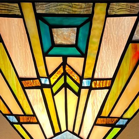 Close-up of stained glass shade on 70 Inch Tiffany Torchiere Floor Lamp With Antique Mission Style, amber cream glow.