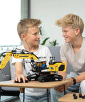 Liebherr R938 Pneumatic Excavator Kit 689 Piece Realistic Builder Model With Pneumatic System Manual Valves And Flow Regulators Ideal For Gearheads 10 And Up Great For Kids Teens And Adults Who Love Engineering. boys playing with assembled pneumatic excavator model