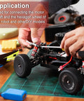 Hands installing 4Pcs 8mm To 8mm Universal Joint Shaft Coupling Kit For Model Cars And Ships on a model car, drive shaft visible.