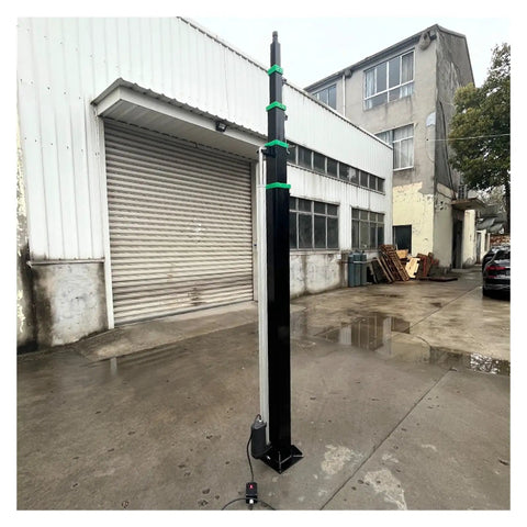 Hella Smooth Electric Lifting Pole Mast With Automatic Telescopic Action And Multi Stage Height Adjustment Cranking Out Eight Meter Reach, standing in a parking area.