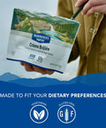 Person holding package of Creme Brulee Freeze Dried Backpacking Meal For Camping And Hiking Emergency Food With 12g Protein Vegetarian