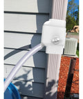 Universal Gutter Downspout Diverter With Built In Filter Screen White Fits 2x3 And Oversize 3x4 Downspouts Reversible Spout For Left Or Right Install Easy No Fuss Setup installed on white downspout with hose