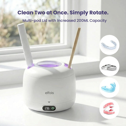 Ultrasonic Retainer Cleaner With UV Light And 45KHz Cleaning Pod on windowsill, displayed with aligners and dentures, multi-pod lid shown.