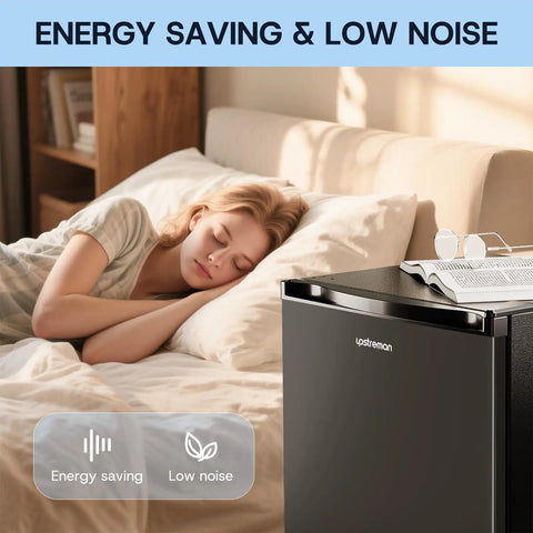 No Fuss And Slick Effortless Setup 30 Cubic Foot Upright Freezer Featuring A Reversible Door Built For Dorm Rooms Tiny Apartments And Home Workspaces In Matte Black Finish next to a sleeping person.