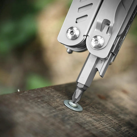 Close-up of Everyday Carry Ready Eighteen In One Stainless Steel Multitool Pliers with a screw bit on wood surface