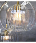 Close-up of Modern Simple Dining Room Pendant Light Creative Personality Bar Caffee Glass Lamp with golden fixture.